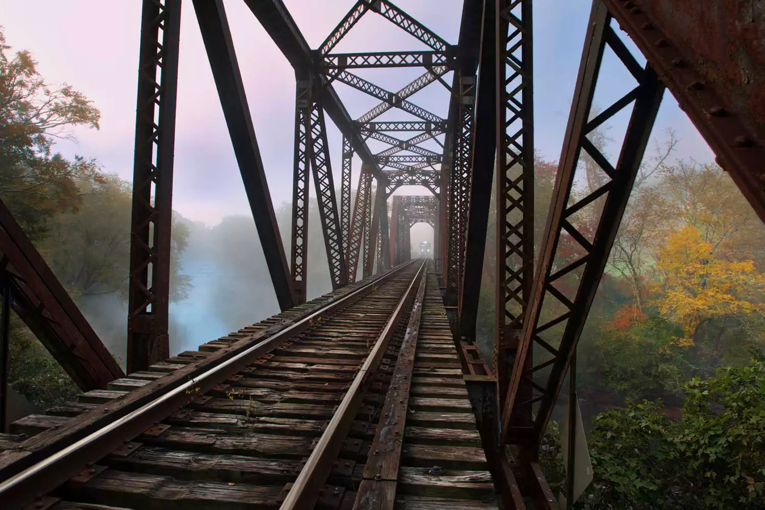 Distant train coming through the fog over a bridge in the Blue Ridge mountains 
