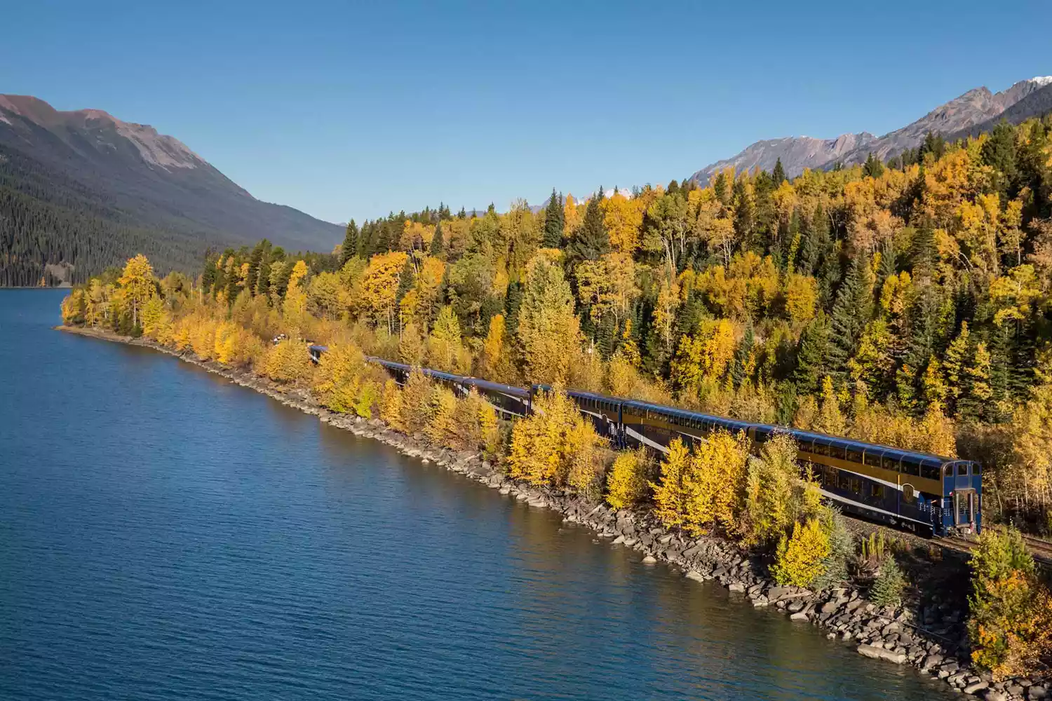 Aerial view of Rocky Mountaineer train along the water during autumn