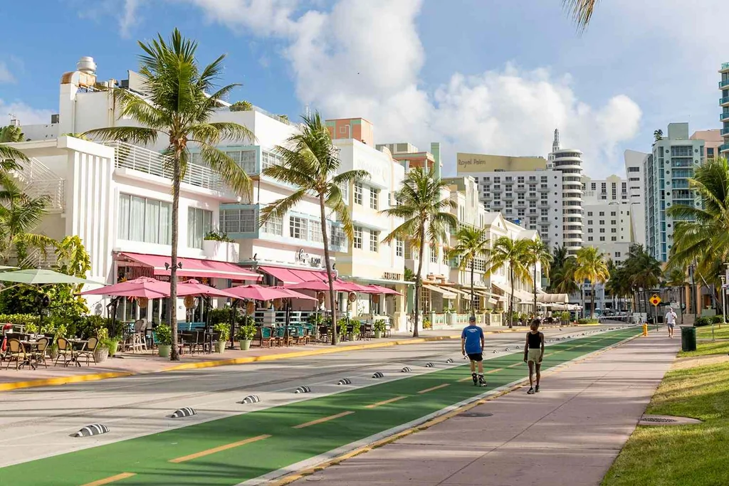 People walking down the street in Miami beach past Art Deco buildings