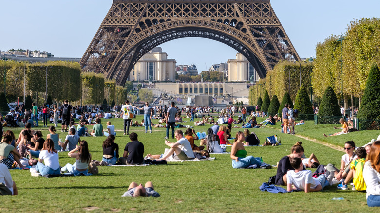 Des gens pique-niquent sous la Tour Eiffel